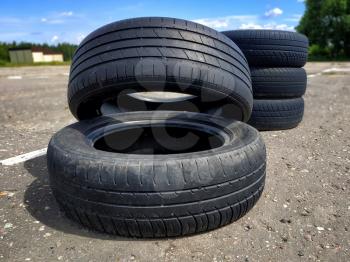 A pile of old car tires lie