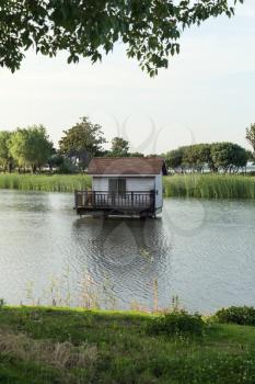 The cottage over the lake in the public park. Photo in Suzhou, China.