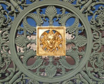 Ancient baroque golden mask on Palazzo Reale (The Royal Palace) fence in Turin Italy