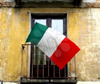 Italian flag on a old balcony with grunge wall