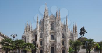 Duomo di Milano (meaning Milan Cathedral) church with palm trees in Milan, Italy