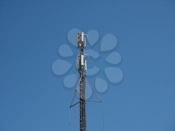 cellular antenna tower and electronic radio transceiver equipment part of a cellular network over blue sky