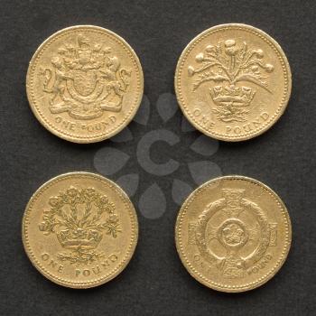British Pounds coins (UK currency) over a dark background