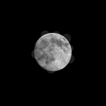 Full moon over the black sky in black and white