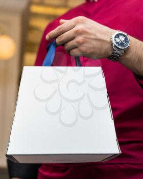 Man holding white box