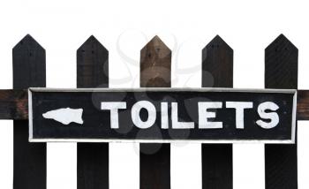 Royalty Free Photo of a Vintage Toilet Sign on a Wooden Fence