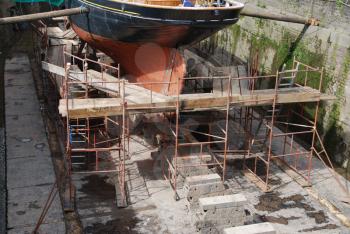 Royalty Free Photo of Antique Boat Preparation at Dry Docks
