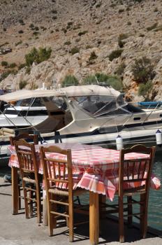 Royalty Free Photo of an Outdoor Restaurant Setting in Kalymnos Island Port, Greece