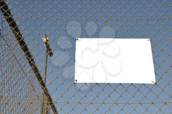 Royalty Free Photo of a Sign on a Fence
