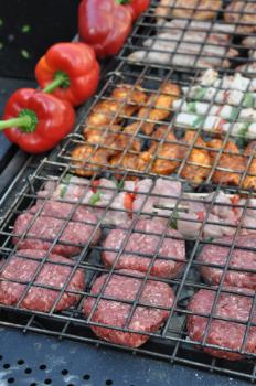 Royalty Free Photo of Meat and Peppers on a Barbecue