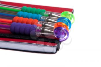 Royalty Free Photo of Pens on a Notebook