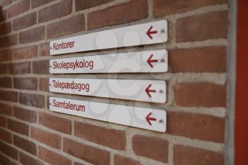 Signs to offices and school nurse in school building