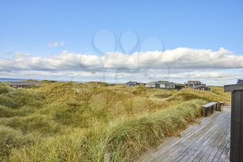 view from beach house of large green filed and blue sky