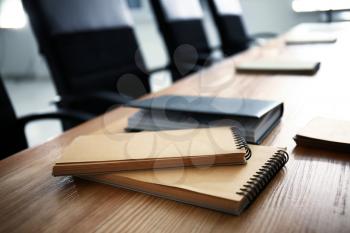 Notebooks on table indoors. Business meeting in conference hall�
