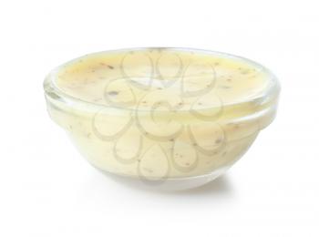 Tasty yellow sauce in glass bowl on white background�
