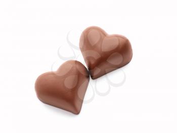 Tasty heart-shaped chocolate candies on white background�