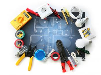 Electrician's supplies with electrical scheme on white background�