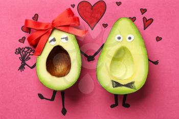 Funny avocado couple on color background�