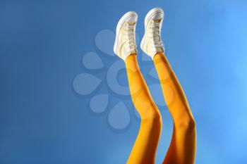Legs of beautiful young woman in tights on color background�