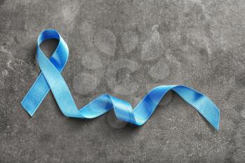 Blue ribbon on grey background. Prostate cancer concept�