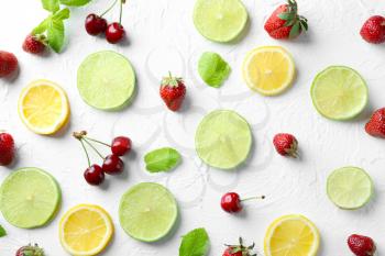 Composition with tasty ripe fruits and berries on light background�