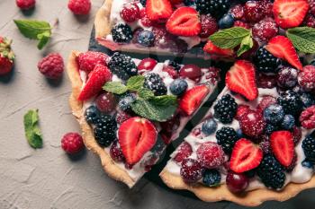 Delicious pie with ripe berries on table�