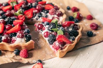 Delicious pie with ripe berries on table, closeup�