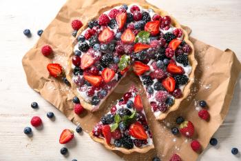 Delicious pie with ripe berries on table, top view�