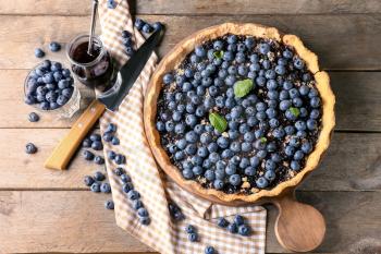 Delicious blueberry pie on wooden table�