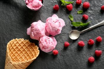 Composition with tasty raspberry ice-cream on slate plate�