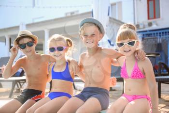 Cute children near swimming pool on summer day�