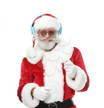 Portrait of Santa Claus listening to music and dancing on white background�
