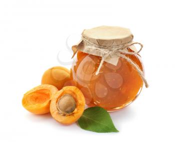 Jar with sweet apricot jam and fresh fruit on white background�