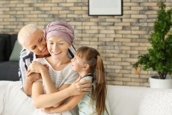 Woman after chemotherapy with her family at home�