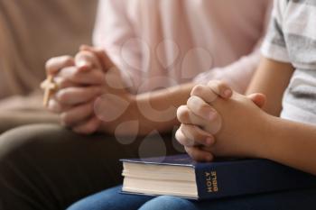 Little boy and his mother praying at home, closeup�