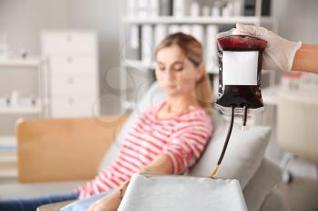 Woman donating blood in hospital�
