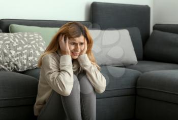 Woman having panic attack at home�