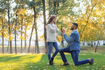 Young man proposing to his beloved in autumn park�