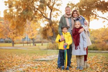 Happy family in autumn park�