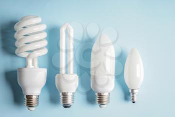 Different light bulbs on color background�