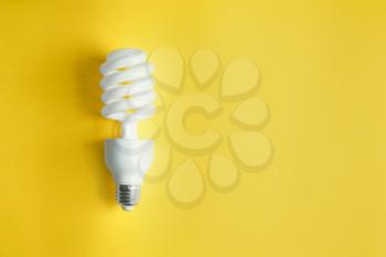 Modern light bulb on color background�