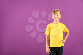 Cute boy in t-shirt on color background�