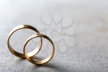 Wedding rings on grey background�