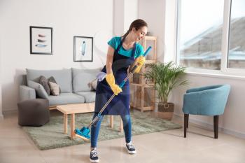 Female janitor having fun while cleaning flat�