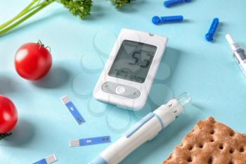 Digital glucometer with lancet pen and healthy food on color background. Diabetes diet�