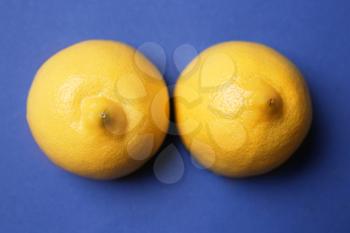 Fresh juicy lemons on color background. Erotic concept�