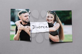 Torn photo of happy couple on grey background. Concept of divorce�