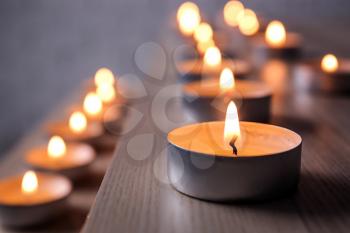 Burning candles on table, closeup�