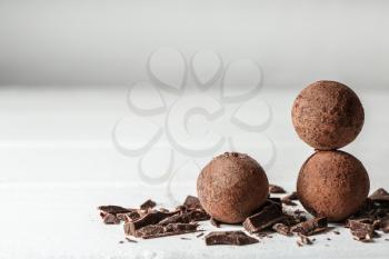Tasty sweet truffles on white table�