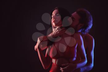 Passionate young couple on dark background�